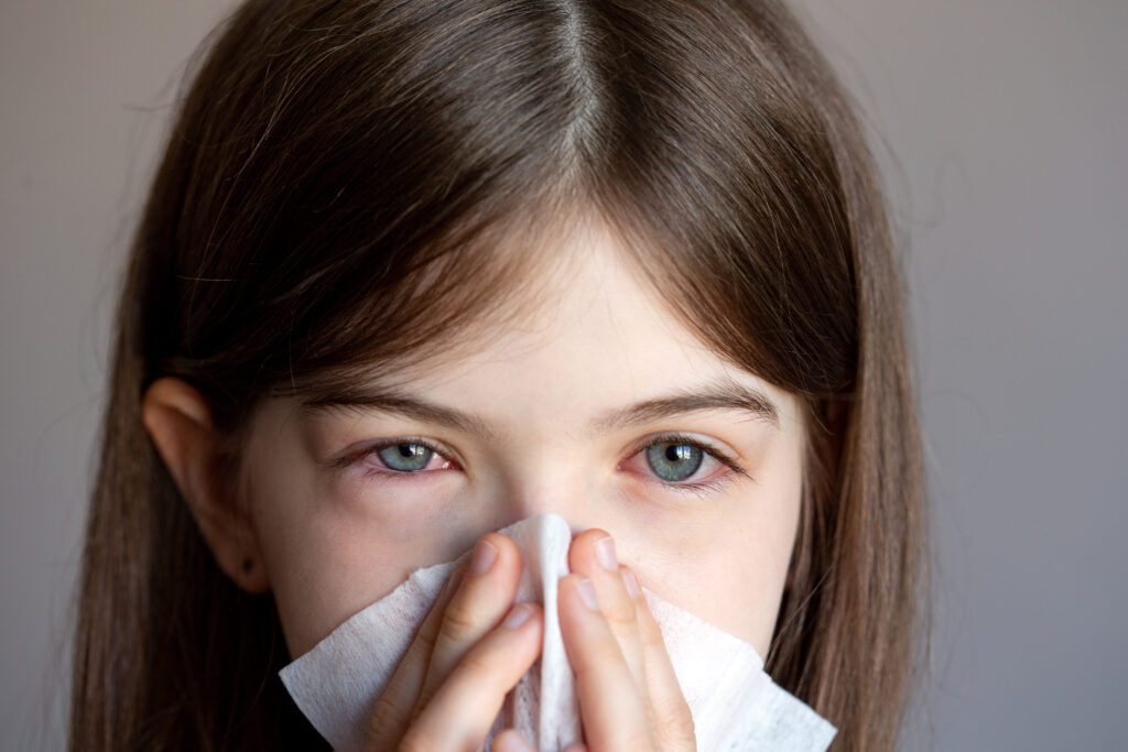 The,young,girl,is,allergic,,she,blows,her,nose,in